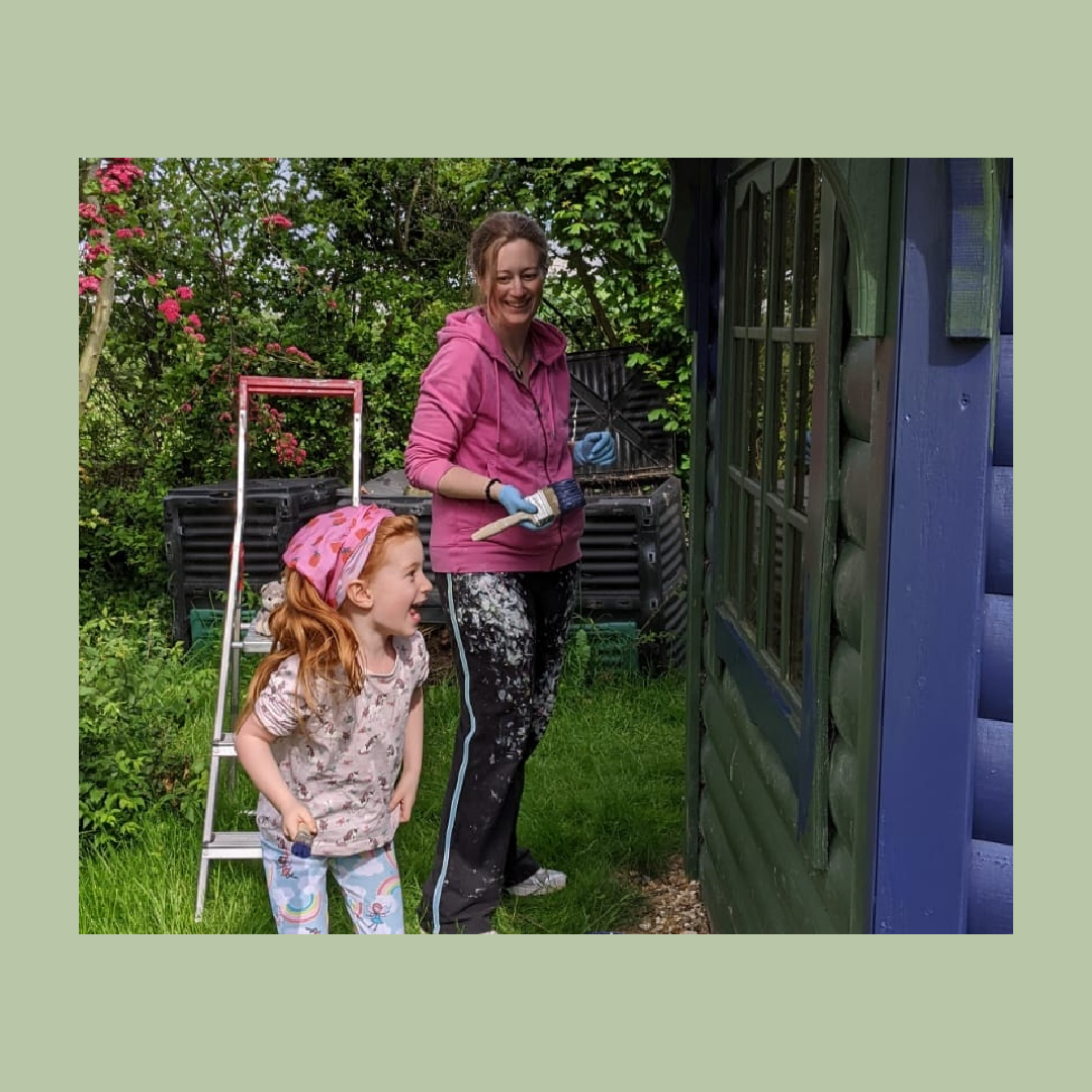 Emma Rose-Roberts, hypnotherapist painting the Hypno Hut with her daughter ("Mini Me")